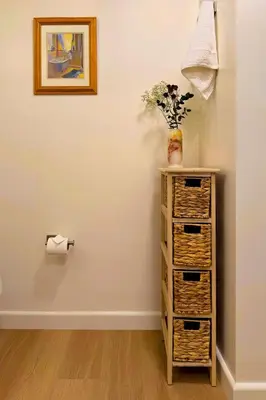 a dresser with a vase and a toilet paper roll at Luxury Designer Hillcrest Apartment with Pool & Gym in San Diego