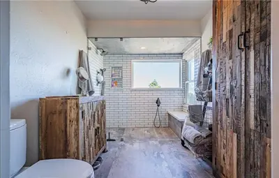 a bathroom with a toilet and a tub and a window at Panoramic view in San Marcos