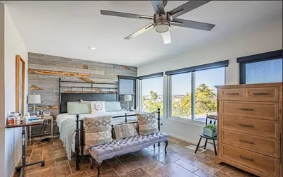 a bedroom with a bed and a ceiling fan at Panoramic view in San Marcos