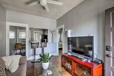 a living room with a large flat screen tv at Entire Building Sleeps 20 I Little Italy in San Diego