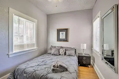 a bedroom with a bed and two windows at Entire Building Sleeps 20 I Little Italy in San Diego