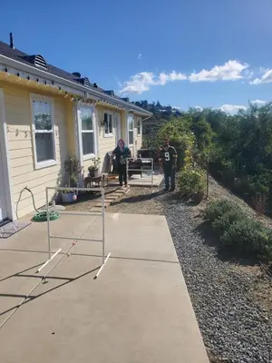 two people standing on a porch of a house at Beverlys Hilltop Retreat in Fallbrook