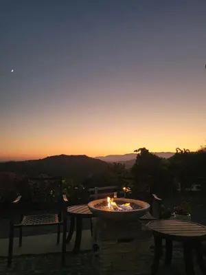 a fire pit with a sunset in the background at Beverlys Hilltop Retreat in Fallbrook