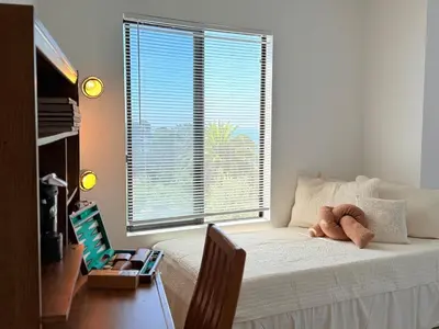 a bedroom with a bed with a teddy bear on it at 6BR5BA Hot Tub Steps to Beach Parking Pet Friendly in San Diego
