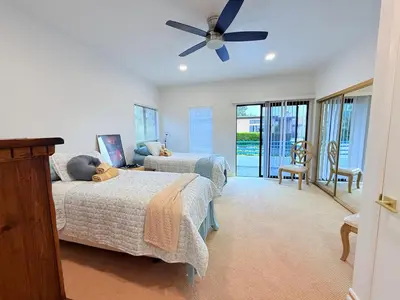 a bedroom with two beds and a ceiling fan at 6BR5BA Hot Tub Steps to Beach Parking Pet Friendly in San Diego