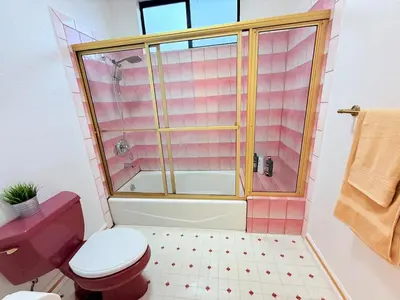 a bathroom with a red toilet and a shower at 6BR5BA Hot Tub Steps to Beach Parking Pet Friendly in San Diego