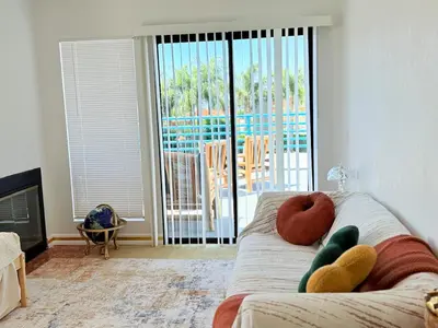 a living room with a couch with two donuts on it at 6BR5BA Hot Tub Steps to Beach Parking Pet Friendly in San Diego