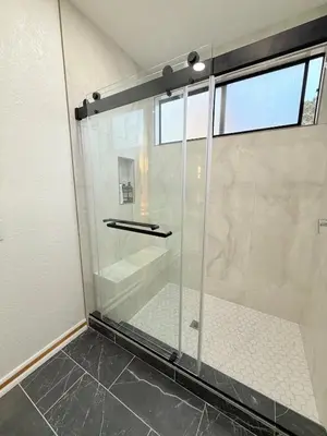 a shower with a glass door in a bathroom at 6BR5BA Hot Tub Steps to Beach Parking Pet Friendly in San Diego