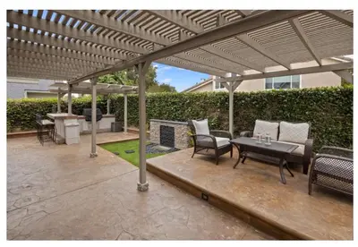 a patio with a table and chairs under a pergola at Dream vacation home in Laguna Hills