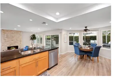 a kitchen with a sink and a table with chairs at Dream vacation home in Laguna Hills