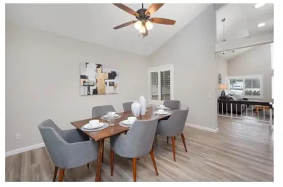 a dining room with a table and chairs and a ceiling fan at Dream vacation home in Laguna Hills