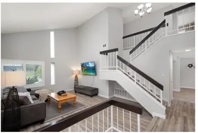 a living room with a staircase and a couch at Dream vacation home in Laguna Hills