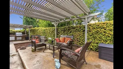 a patio with chairs and a table under a pergola at Dream vacation home in Laguna Hills