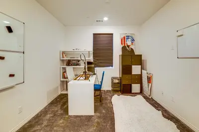 a room with white walls and a desk and a shelf at Family Getaway with Pool, 8 Mi to Lake Elsinore! in Wildomar