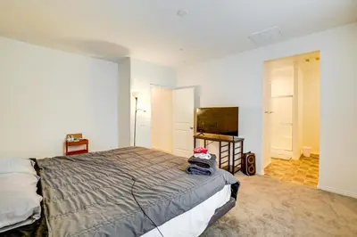 a bedroom with a bed and a flat screen tv at Family Getaway with Pool, 8 Mi to Lake Elsinore! in Wildomar