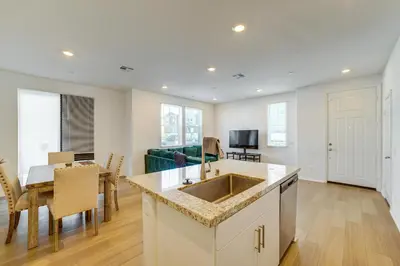 a kitchen and living room with a sink and a table at Family Getaway with Pool, 8 Mi to Lake Elsinore! in Wildomar