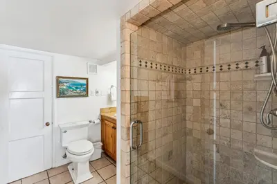 a bathroom with a shower and a toilet and a sink at Oceanfront St Anns Beach Laguna Beach Private Beach Stairs To The Sand in Laguna Beach