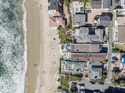 an overhead view of a beach with houses and the ocean at Oceanfront St Anns Beach Laguna Beach Private Beach Stairs To The Sand in Laguna Beach