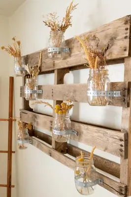 a reclaimed wood pallet wall with jars and flowers at Boho Chic Cottage Walk to Cafes Outdoor Lounge in San Diego