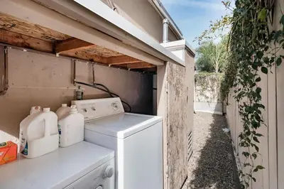 a laundry room with a washer and dryer at Boho Chic Cottage Walk to Cafes Outdoor Lounge in San Diego