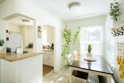 a kitchen and dining room with a table and chairs at Boho Chic Cottage Walk to Cafes Outdoor Lounge in San Diego