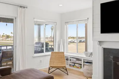 a living room with a fireplace and a television at Remodeled 4BR Bayfront Home | Sleeps 12 | Stunning Views + BBQ Patio in San Diego