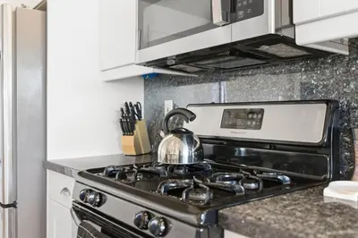 a tea kettle sitting on top of a stove in a kitchen at Remodeled 4BR Bayfront Home | Sleeps 12 | Stunning Views + BBQ Patio in San Diego
