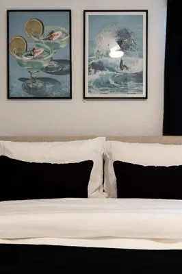 a bedroom with three framed pictures above a bed at Walk to Balboa and Zoo Central Renovated Villa in San Diego