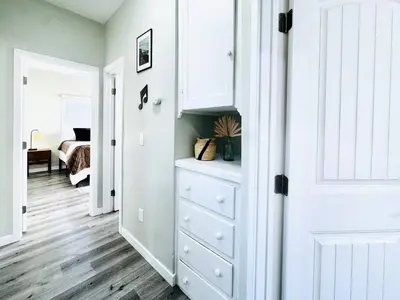 a room with a white cabinet and a bedroom at A Walkable Music-Themed Escape Near Downtown in San Diego