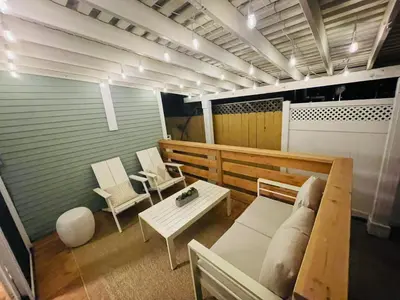 a room with a bench and a table and chairs at The North Park Stay in San Diego in San Diego
