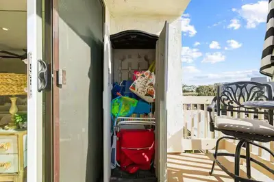 an open door to a balcony with a table and chairs at Beachfront Resort-sunset views deck & luxe king in Oceanside