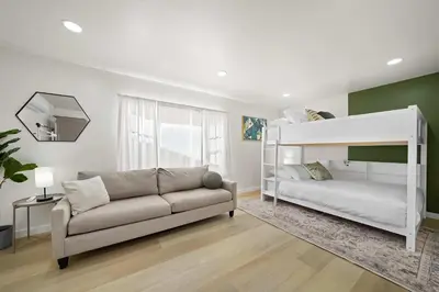 a living room with a couch and a bunk bed at Stylish Retreat Near Mission Bay with Games & Firepit in San Diego