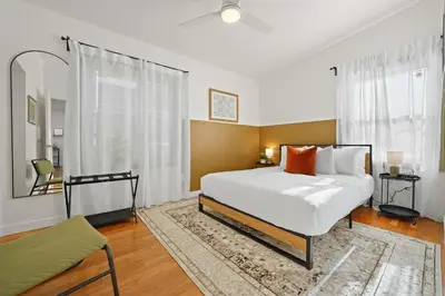 a bedroom with a large white bed and a window at Stylish Retreat Near Mission Bay with Games & Firepit in San Diego