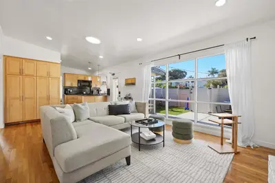 a living room with a couch and a table at Stylish Retreat Near Mission Bay with Games & Firepit in San Diego