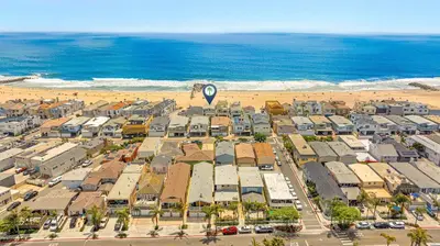 an aerial view of a beach with a hot air balloon at 3Br Oceanfront Home W Balcony Right Over The Sand By Beachview Rentals in Newport Beach
