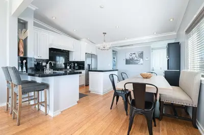 a kitchen and dining room with a table and chairs at 3Br Oceanfront Home W Balcony Right Over The Sand By Beachview Rentals in Newport Beach