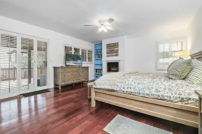 a bedroom with a bed and a ceiling fan at 4Br Home, One House From Balboa Beach W Rooftop Deck By Beachview Rentals in Newport Beach