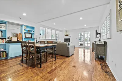 a kitchen and living room with a table and chairs at 4Br Home, One House From Balboa Beach W Rooftop Deck By Beachview Rentals in Newport Beach