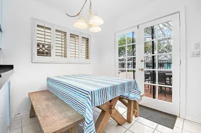 a kitchen with a table with a blue and white striped table cloth at 4Br Home, One House From Balboa Beach W Rooftop Deck By Beachview Rentals in Newport Beach