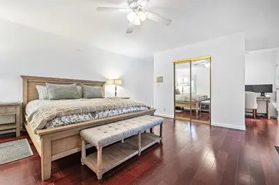 a bedroom with a bed and a ceiling fan at 4Br Home, One House From Balboa Beach W Rooftop Deck By Beachview Rentals in Newport Beach
