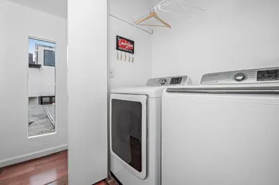 a microwave oven sitting next to a washing machine at 4Br Home, One House From Balboa Beach W Rooftop Deck By Beachview Rentals in Newport Beach
