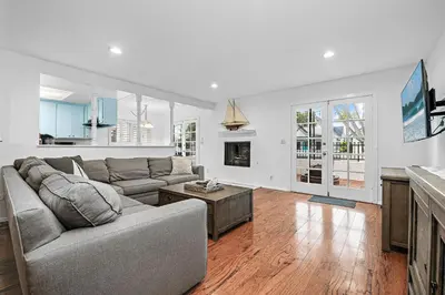 a living room with a couch and a table at 4Br Home, One House From Balboa Beach W Rooftop Deck By Beachview Rentals in Newport Beach