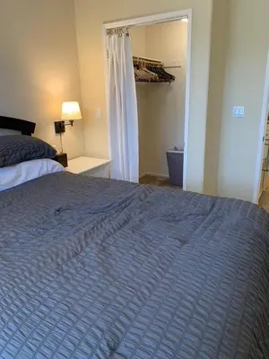 a bedroom with a bed with a blue blanket at Exclusive Top Floor 1 bedroom in central Irvine one month min in Irvine