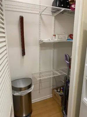 a walk in closet with a trash can and shelves at Exclusive Top Floor 1 bedroom in central Irvine one month min in Irvine