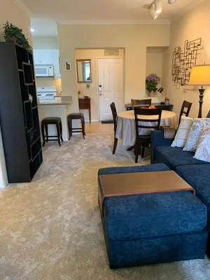 a living room with a couch and a dining room at Exclusive Top Floor 1 bedroom in central Irvine one month min in Irvine