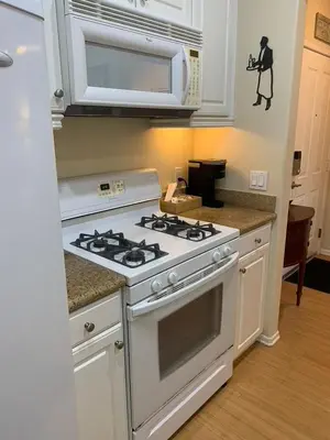 a kitchen with a white stove and a microwave at Exclusive Top Floor 1 bedroom in central Irvine one month min in Irvine