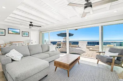 a living room with a couch and views of the beach at 3Br Oceanfront Home W Patio Right On The Sand By Beachview Rentals in Newport Beach