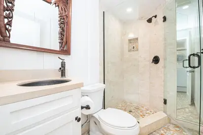 a bathroom with a toilet and a shower at 3Br Oceanfront Home W Patio Right On The Sand By Beachview Rentals in Newport Beach