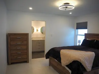a bedroom with a bed and a dresser and a mirror at Luxury 3BR, 2BA Newly Renovated with Huge Backyard in San Diego