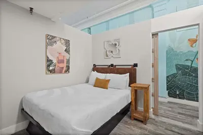 a white bedroom with a bed and a window at Downtown Gaslamp Getaway Stylish 4BR APT in San Diego